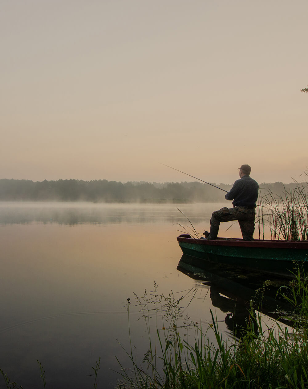 man standing in fishing boat